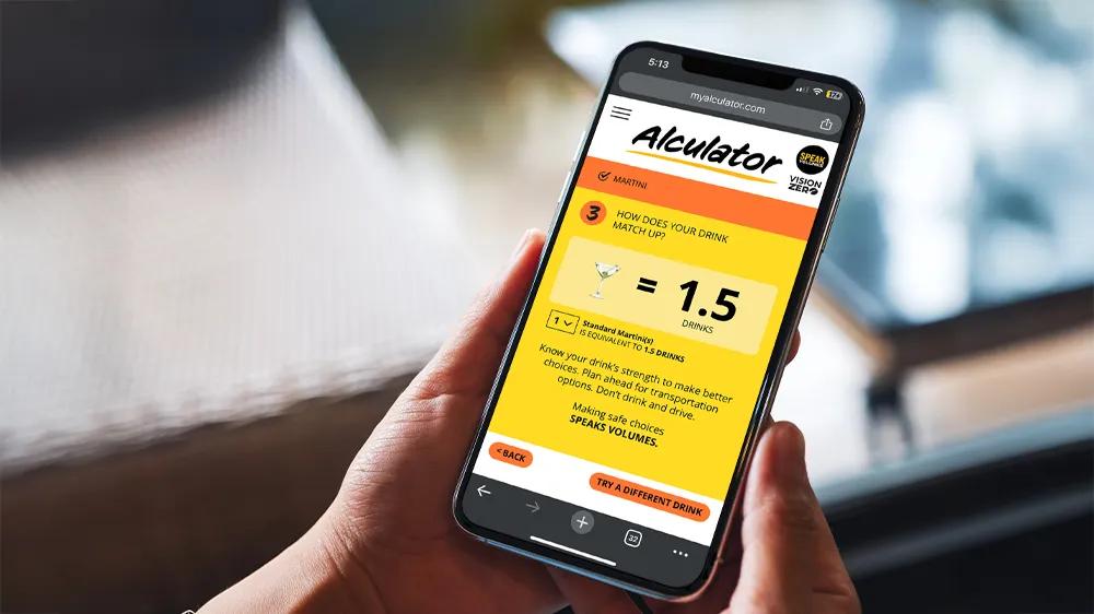 Person using the Speak Volumes ‘Alculator’ web app on a mobile phone, developed by LXE Digital and Level MPLS to promote public safety through drink-strength awareness