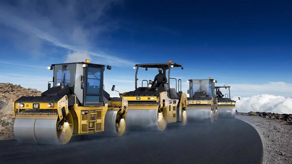 CAT road rollers on a mountain road, part of a visual experience used in the LXE Digital-designed touchscreen kiosk for construction equipment sales
