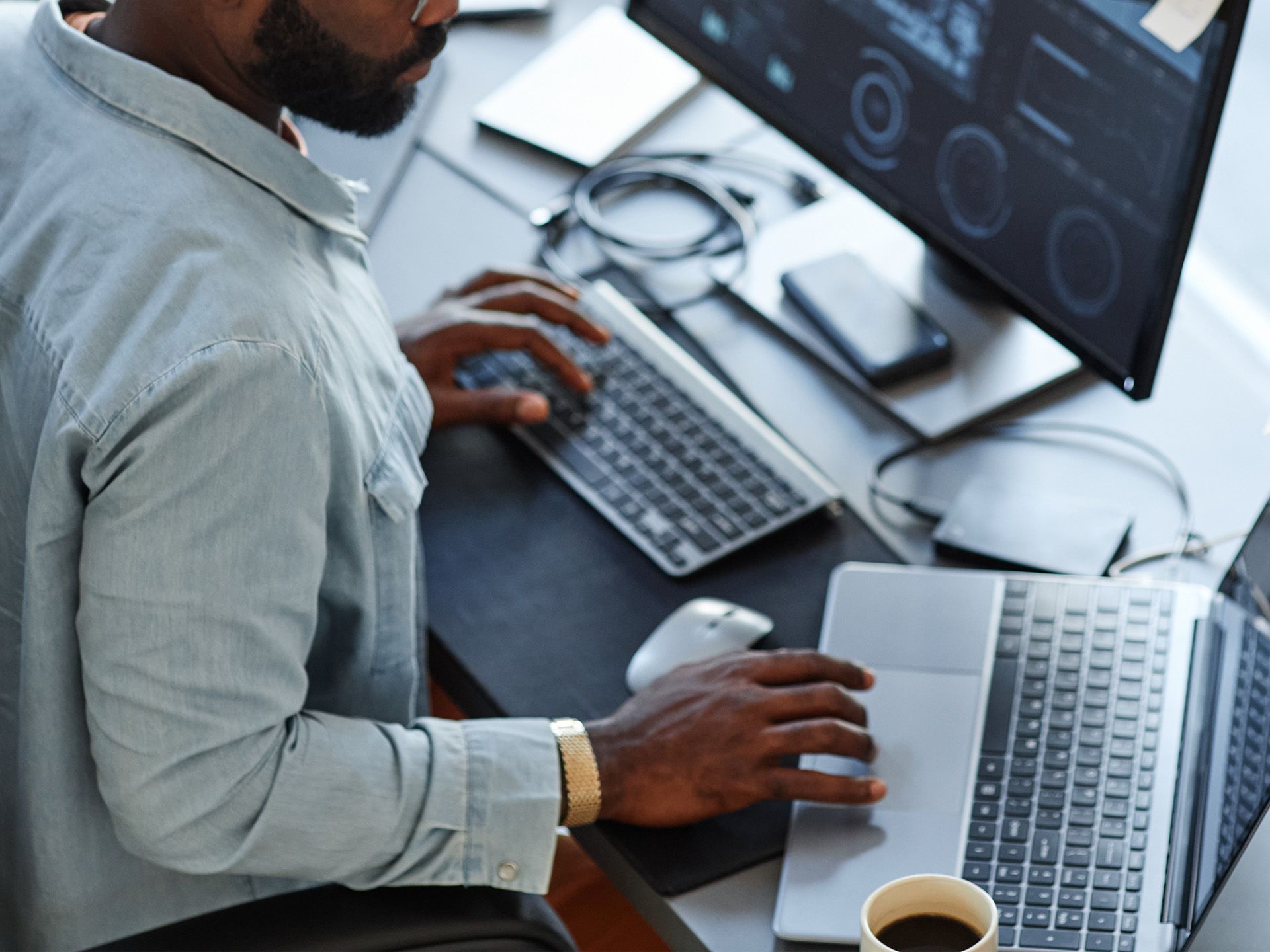 LXE Digital team member working across multiple monitors on a web development project, demonstrating technical expertise and multitasking efficiency