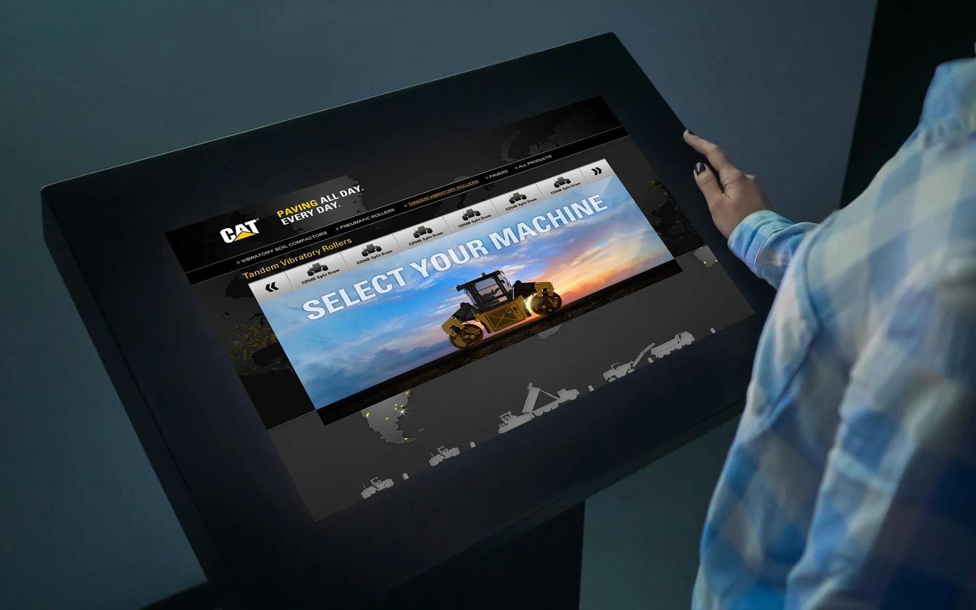 Interactive touchscreen sales kiosk interface for CAT paving machines, developed by LXE Digital to guide users through equipment options